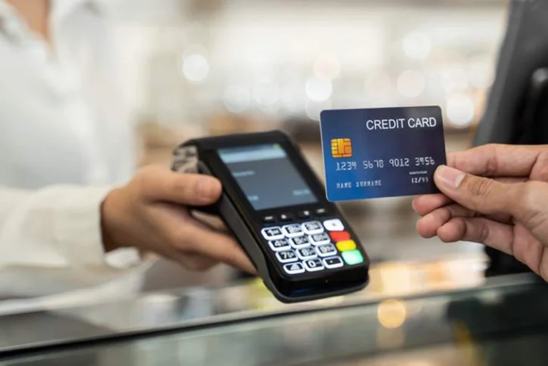 Graphical image of a credit card at a credit card machine reader.