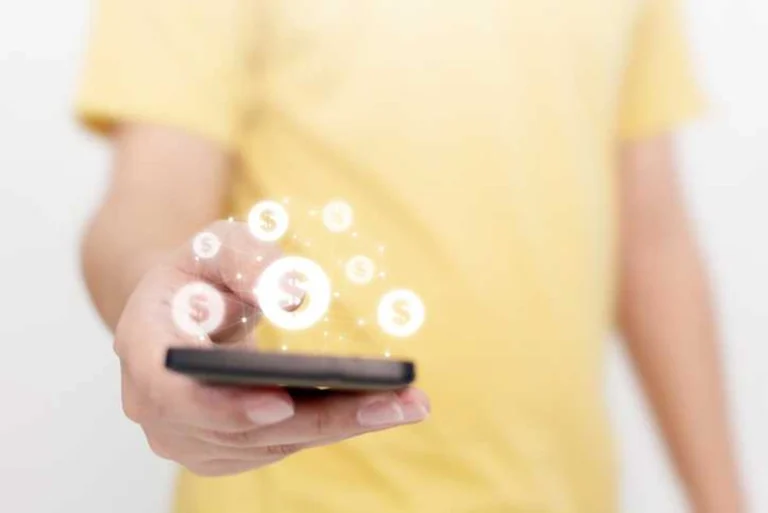 Image of a person in yellow with their smart phone.