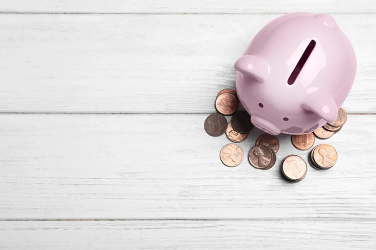 image of the top view of a piggy bank with coins around it.